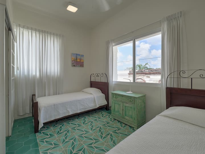 Guest bedroom has 2 single beds and an en suite bathroom.