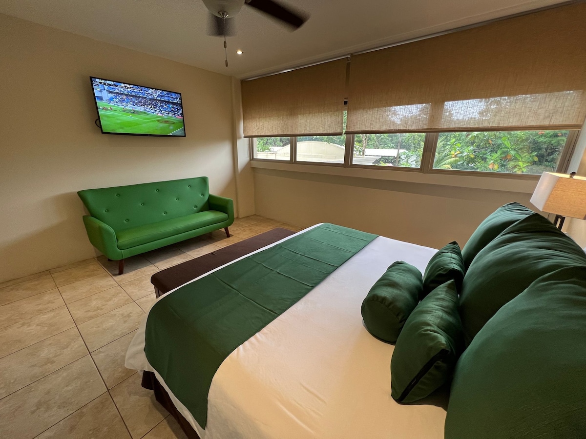 Bedroom with king bed and sofa. 