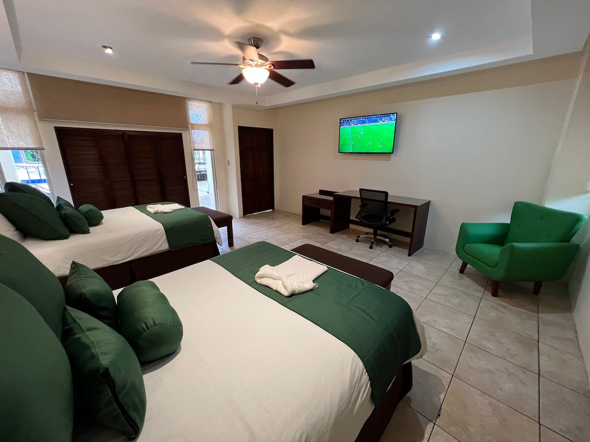 Bedroom with 2 queen beds and desk.