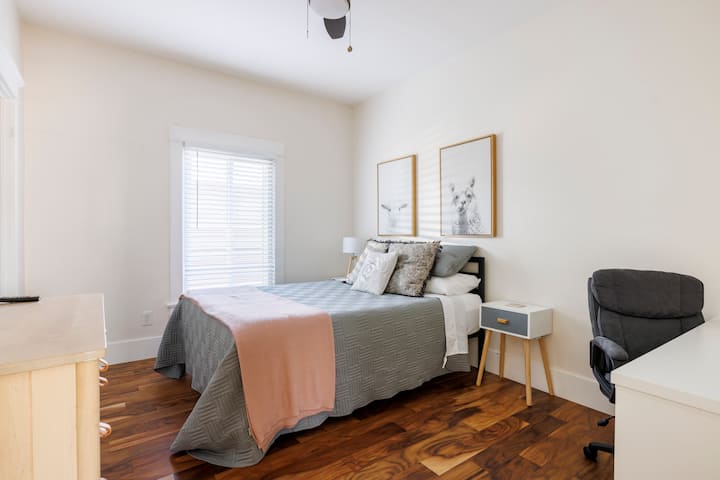 Third guest bedroom with ample light and dedicated workspace 