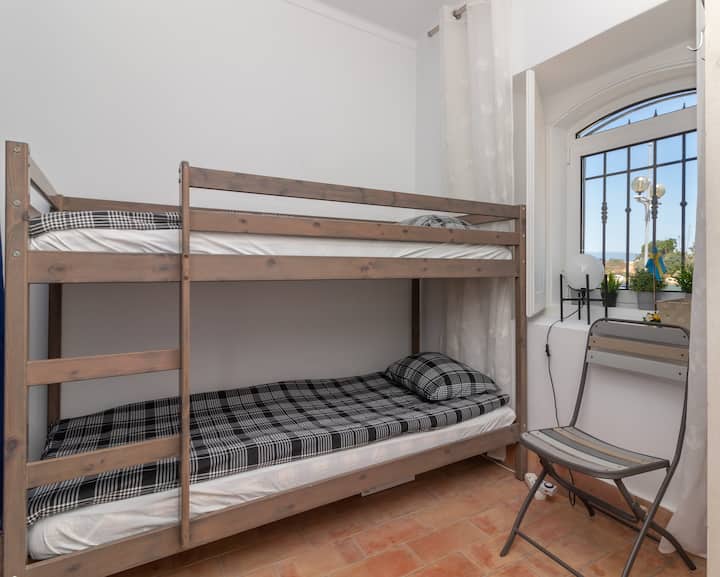 The third bedroom features bunk beds, perfect for accommodating children or additional guests above 4 people.

This room is also equipped with a combined washer and dryer as well as storage space.