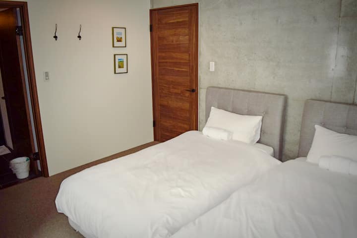 二号卧室带套内卫生间入口，部分显示在左侧