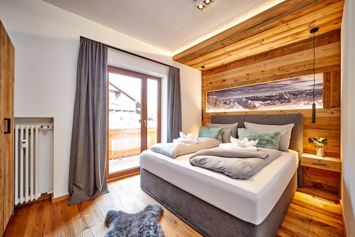 Bedroom with box spring bed & balcony access 