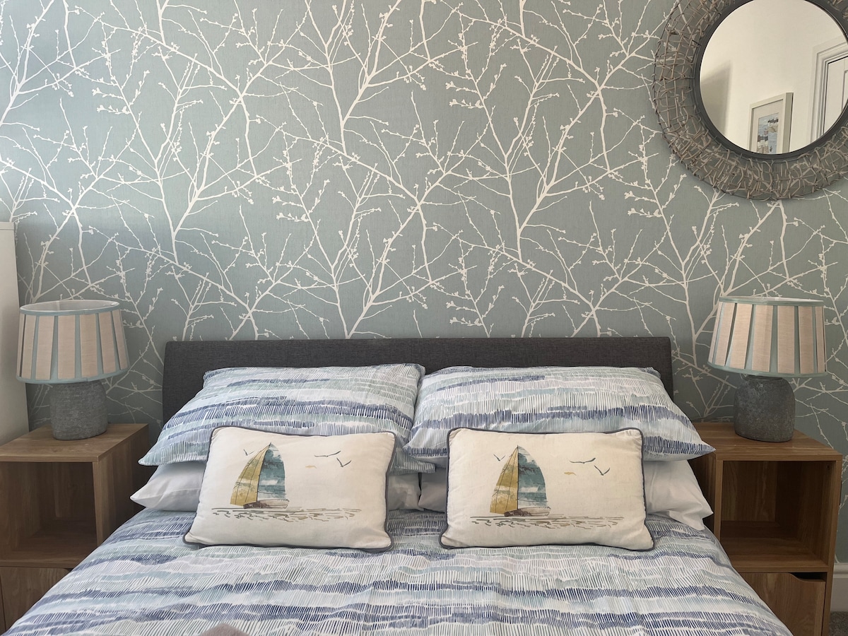 newly decorated Second bedroom with double bed, bedside units, drawers and hanging space