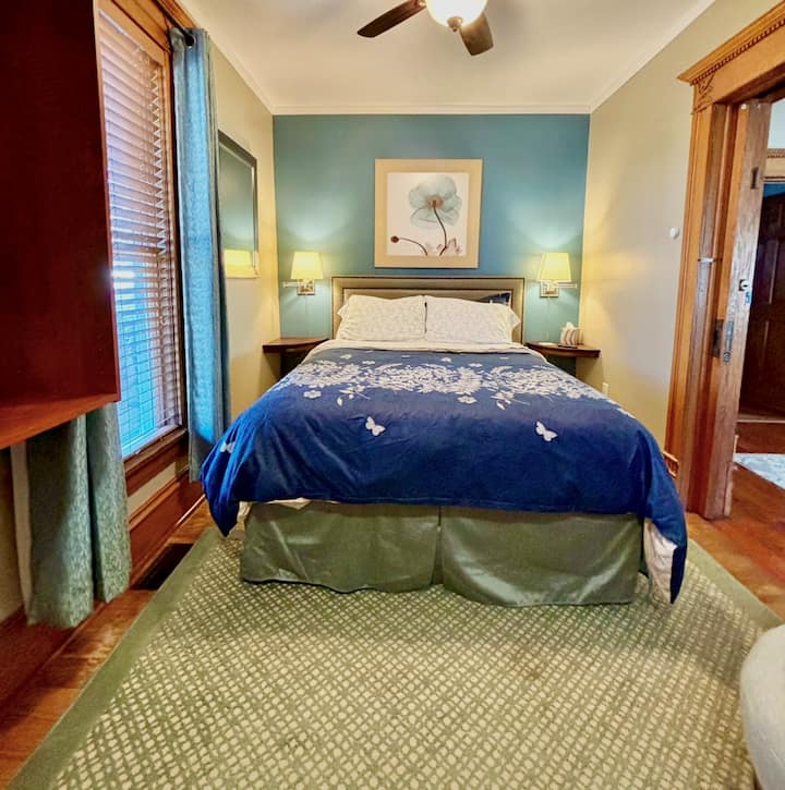 Bedroom Suite 1 - Main Floor: features a queen luxury plush mattress set, quality linens, wall-mount streaming TV, WiFi, Central A/C, closet organizer/storage, swivel chair, bedside lamps, dressing mirror and private ensuite bathroom.