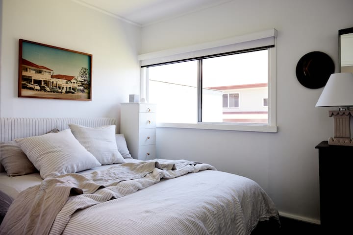 The Front Queen Bedroom complete with French linen bedding, fluffy pillows, block out blinds and ceiling fan. 