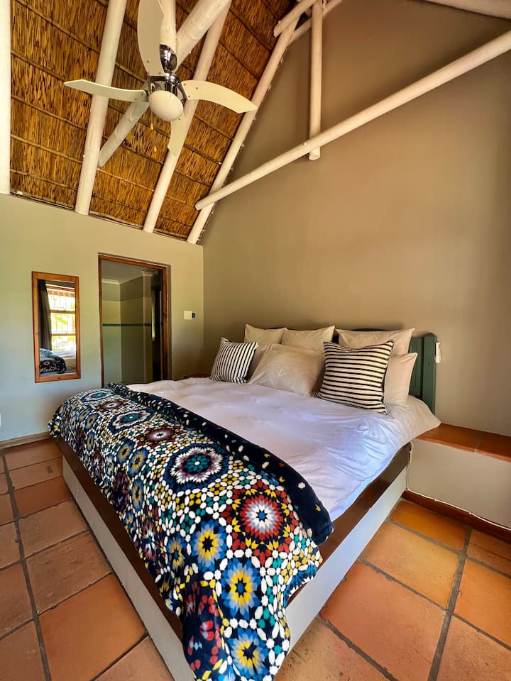 Second bedroom outside in front of pool + en suite bathroom