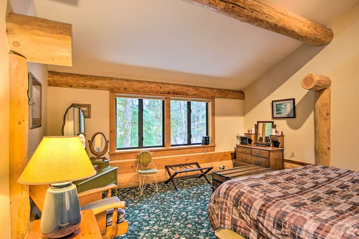 The spacious upstairs master suite offers a sumptuous king-size bed and an expansive private deck with serene forest views.