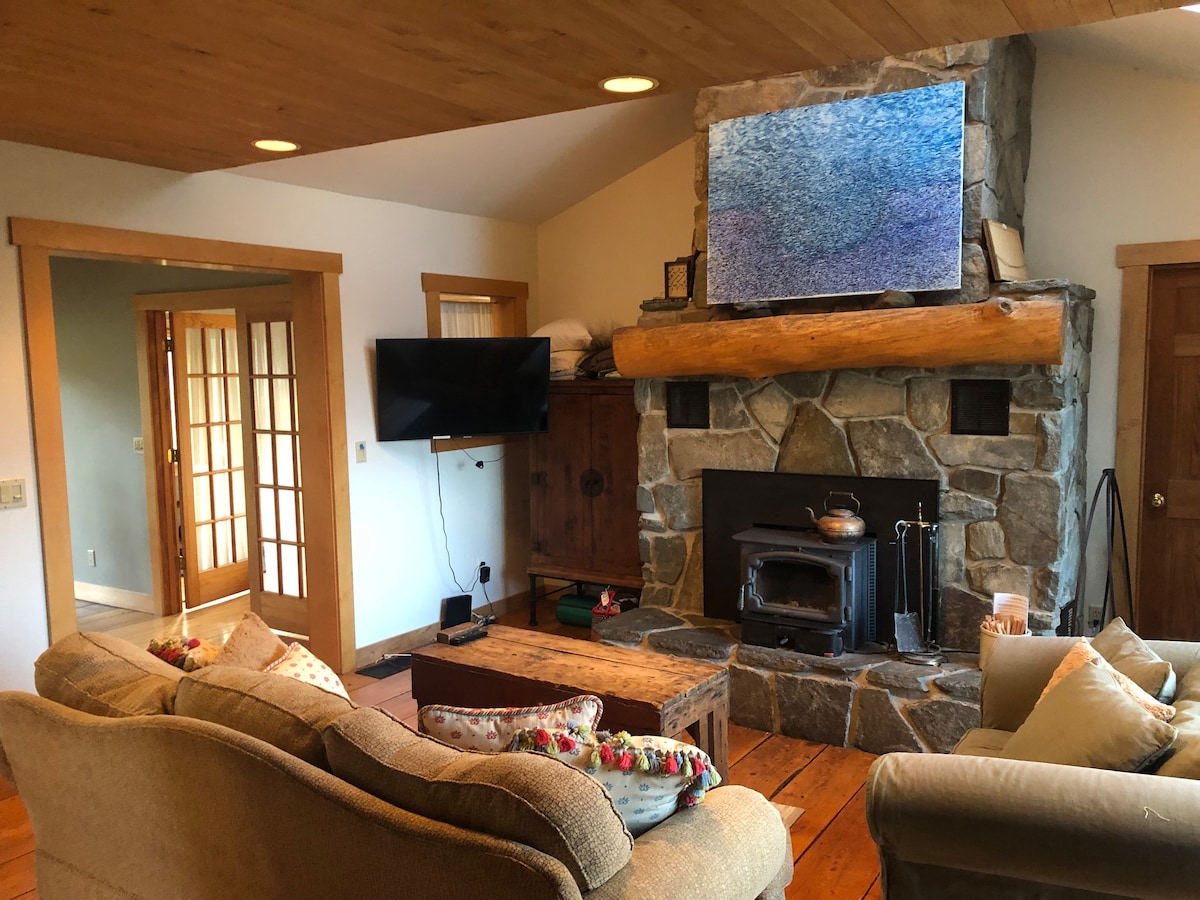 Living room with smart TV and wood burning stove