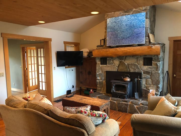 Living room with smart TV and wood burning stove