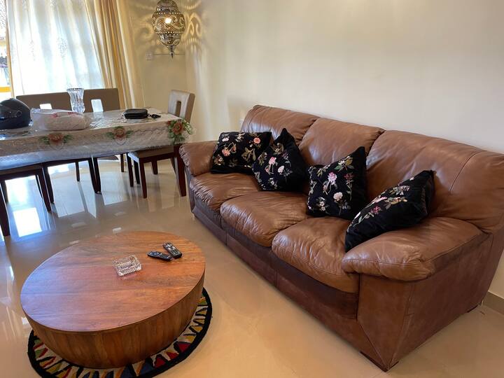 A 3 seater sofa and a tree stump styled table completes the contemporary look of our home ambience