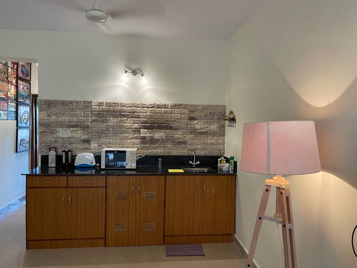 Open Kitchen..will have 
- Induction plate with vessels.
- Microwave
- Electric Kettle
- Toaster
- Mini fridge