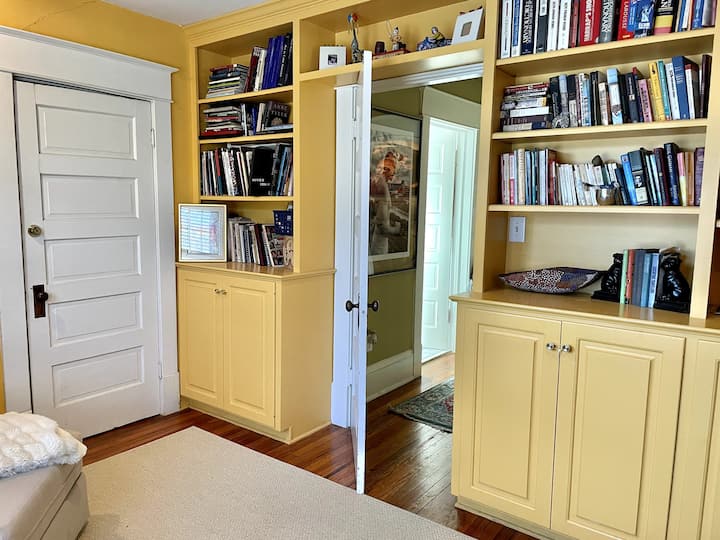 Sitting room bookshelves looking back into hallway and entrance to upstairs bathroom.