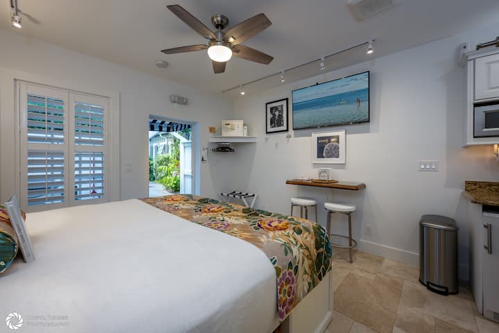 Stepping inside, you are greeted by a 56" Smart TV (don't forget to bring your UN/PW for Netflix, etc.), en electronic safe for valuables, a custom made breakfast nook with swivel bar stools, window with plantation shutters.