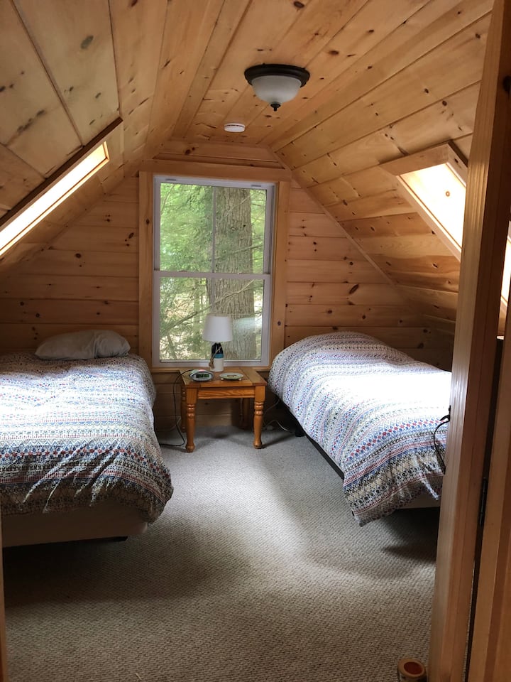 غرفة نوم في الطابق العلوي بسريرين توأمين