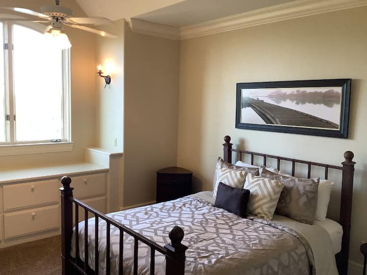 Queen bedroom with private sink and shares a toilet/shower room with the Sailboat bedroom.