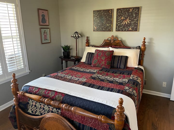Queen bed in large bedroom