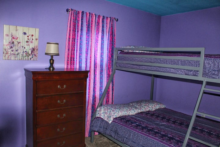 The Purple Room- Twin-over-Full Bunkbed. Located in the downstairs hallway with chest of drawers and lamp.