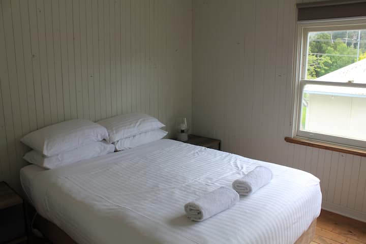 Main bedroom, a queen size bed and plenty of room to place your bags and hang your clothing items.