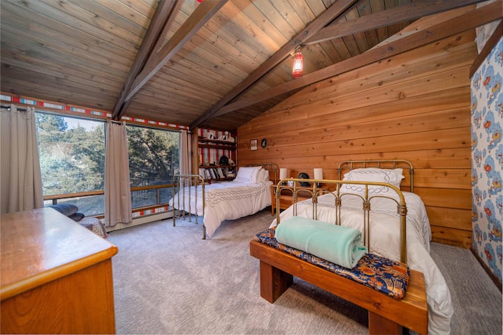 Second floor bedroom with two twin beds.  Great view of the Monument.  Also great view of kids airplane wallpaper.  