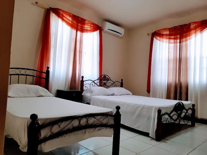 This is what we call the master bedroom. Here you see the two beds that occupy the master bedroom. 
One is a queen sized bed while the other is a single bed.
Fully air conditioned.