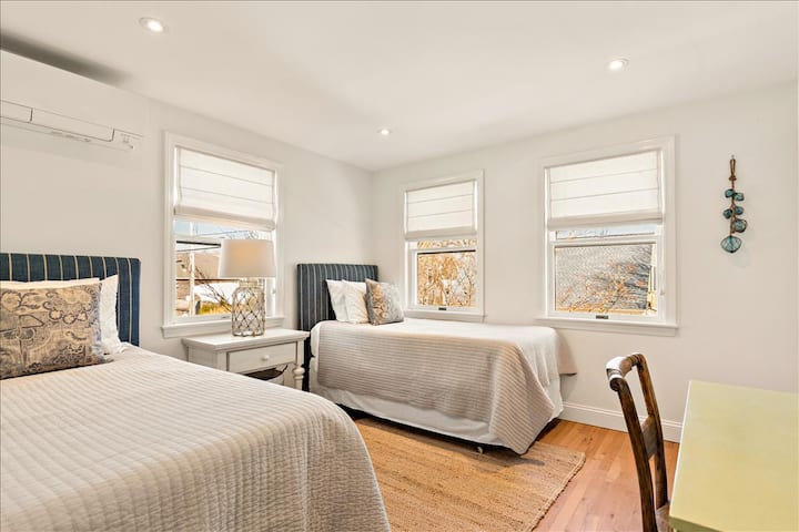 Upstairs bedroom with 2 twin beds and mini split system (air conditioning).