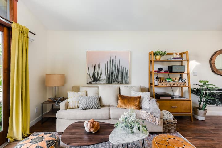 Unwind on our tailored pull-out couch that hides a queen bed with memory foam mattress. Open the double french doors & take in the garden while you unwind.