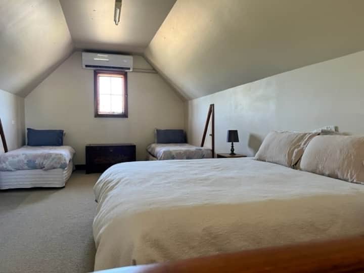 The loft style bedroom can be configured into 4 singles or one King and 2 singles to suit guests' needs. Much research has gone into making the perfect comfy King from 2 singles and pride ourselves on the reviews we have received from our guests