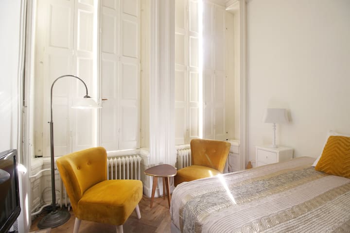 No curtains, but still the original wooden shutters you can open & close.