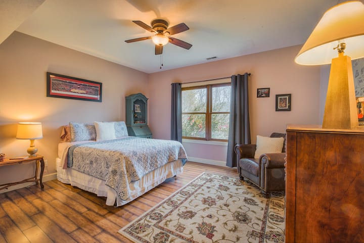Bedroom 2 with queen bed, freshly laundered linens, black out curtains, and a gorgeous view of the exclusively private back yard and patio.