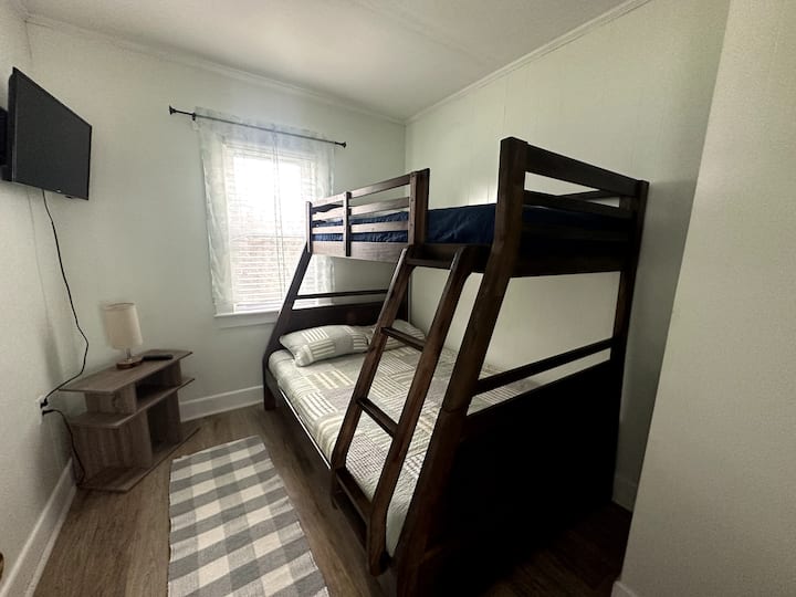 Second bedroom with twin over full bunkbed and small closet