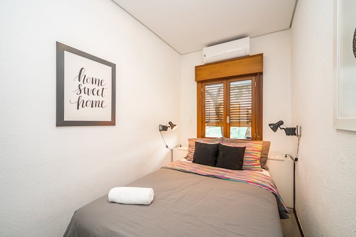 חדר עם מיטה זוגית, מיזוג אוויר, חלונות אטומים לרעש וצל האפלה מובנה בחלון העץ, כמו גם מראה ושידה.