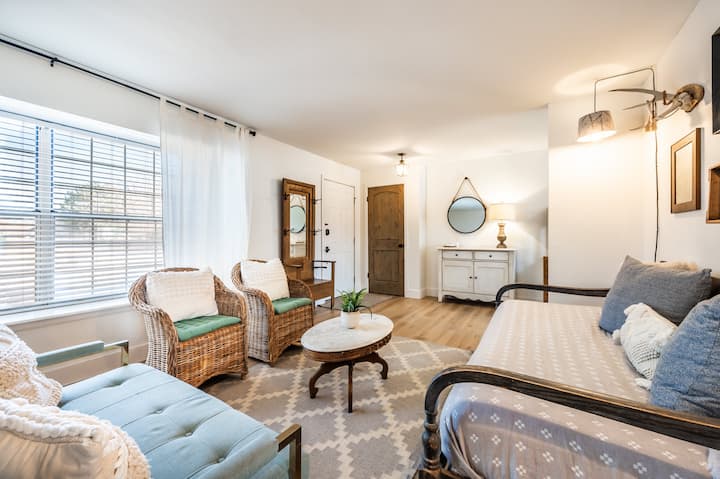 As you enter through the front door, you’re greeted by the first living room featuring a sleeper sofa, love seat, and two chairs. 