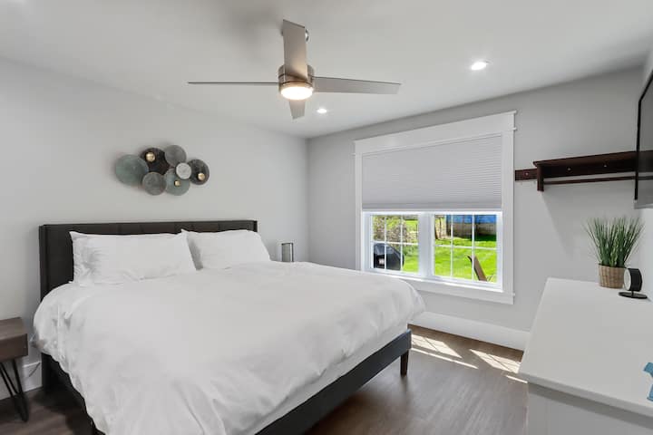 Master bedroom with king size bed and flat screen tv.