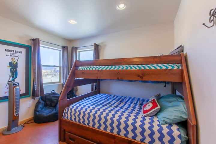 Second bedroom with full mattress on the bottom, twin on top bunk bed, smart TV.