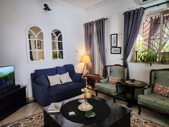 Living Room with Comfortable Seating and a High Definition Smart TV and a Surround Sound Home Theatre System for your Entertainment
