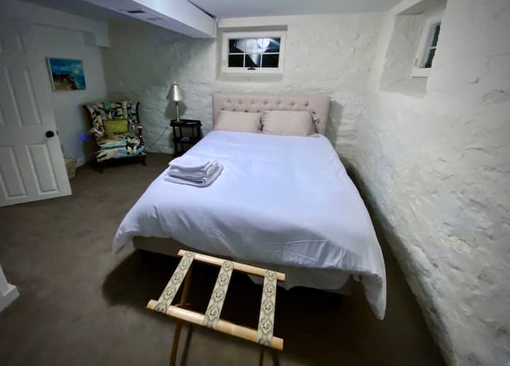 The second downstairs bedroom has a new queen bed frame and mattress. Stairs needed to access.