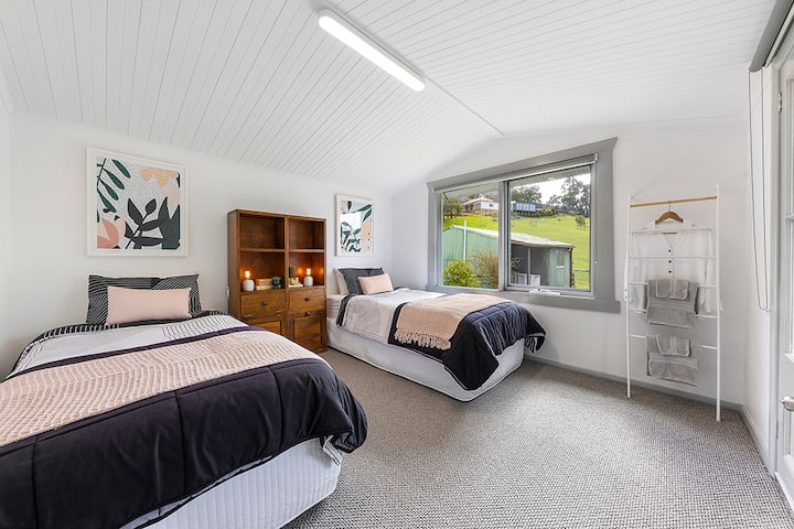 King singles view 2: Matchboard ceiling, large windows with views to the garden and French doors leading out to the courtyard