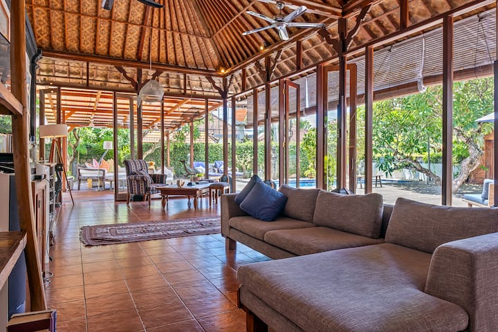 Spacious indoor living room, fully air-conned with comfortable sofa set and library.