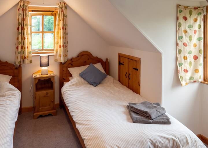 two single beds in the smaller bedroom