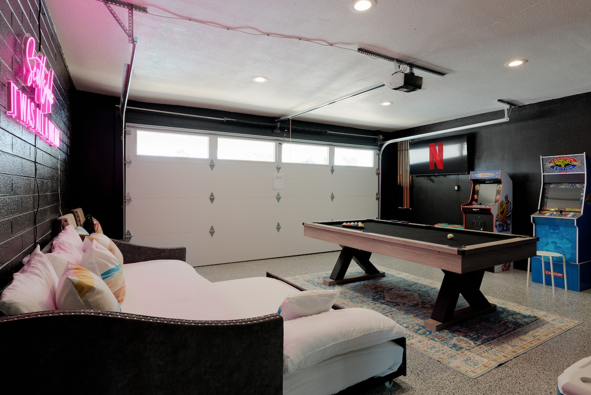 Garage Game Room/4th Bedroom. Air conditioned & heated. Features: Twin over Twin Trundle Daybed. 50" Flat Screen Smart Roku TV, Pool Table (converts to table tennis), Pac Man & Street fighter Arcade Games, Yoga Mats, Workout Gear, & Darts.