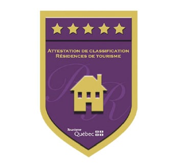 An official tourism classification badge is displayed, featuring a rich purple background with gold accents. The emblem includes a stylized house icon, indicating the property's quality and standards within the tourism sector.
