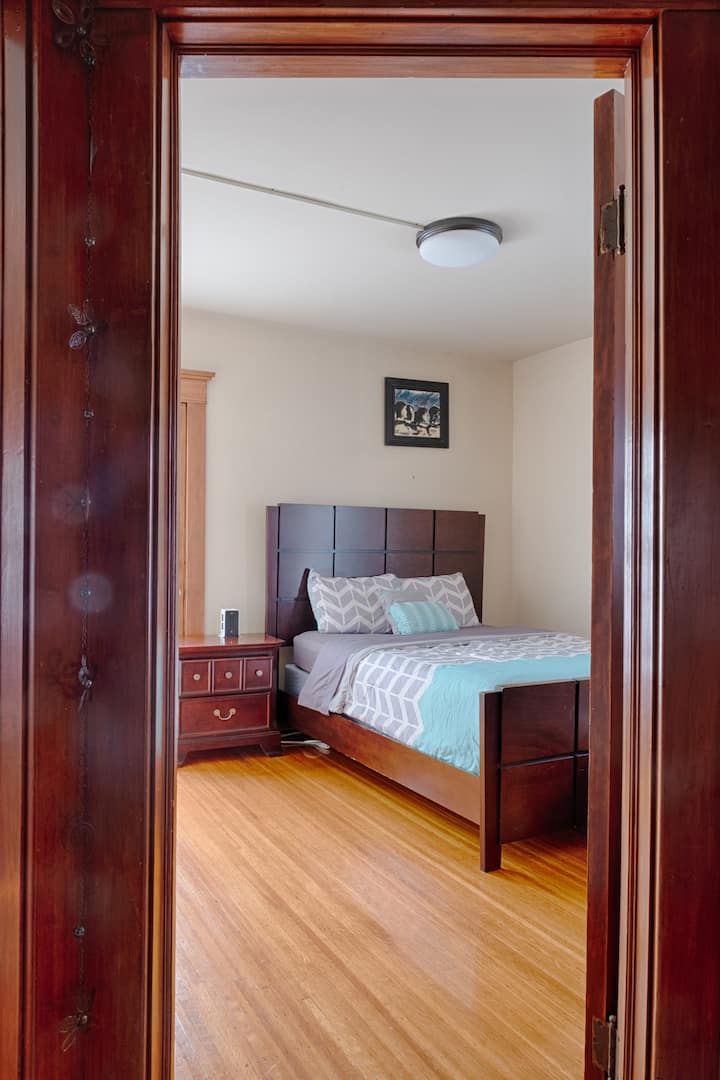Queen bed. Bedroom #3. Second floor. A door to the back balcony.