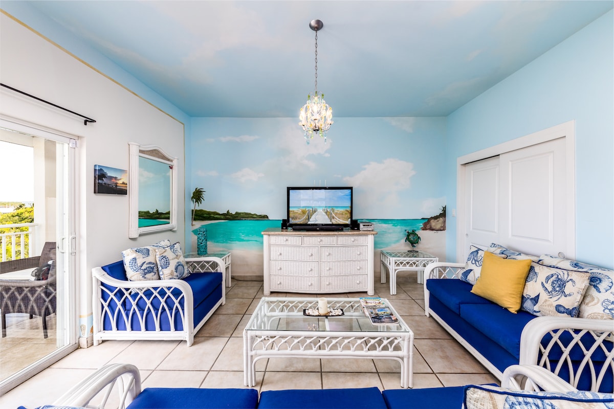 คอนโดให้เช่าส่วนตัวในบีชรีสอร์ท - ห้องนั่งเล่นพร้อมระเบียงกลางแจ้งมองเห็นถนนเกรซเบย์  สมบูรณ์แบบหรืออาบแดดส่วนตัวเก้าอี้นั่งเล่นและที่นั่ง