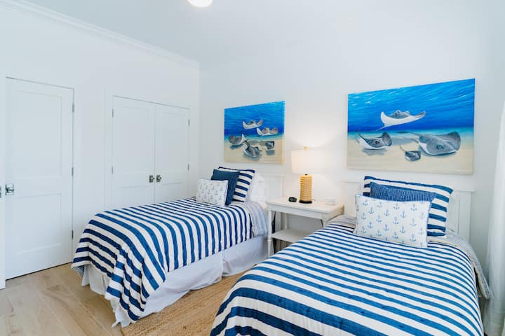 Twin bedroom and entry door is beyond the closets