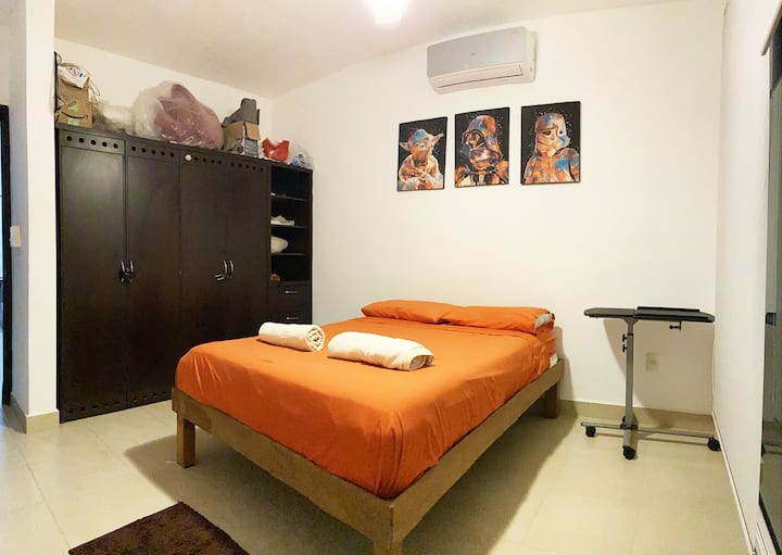 The second bedroom with a single bed, air conditioning, closet and nice view of the private garden
