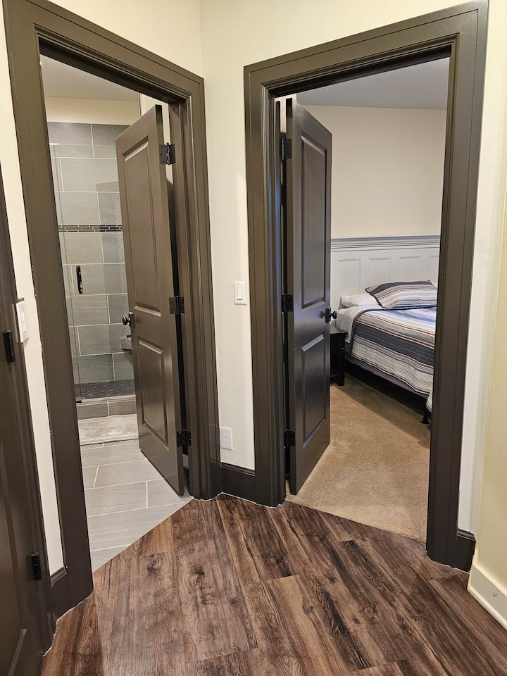 Optional 1 bedroom apartment connected with upstairs.  View of bedroom and bathroom entry