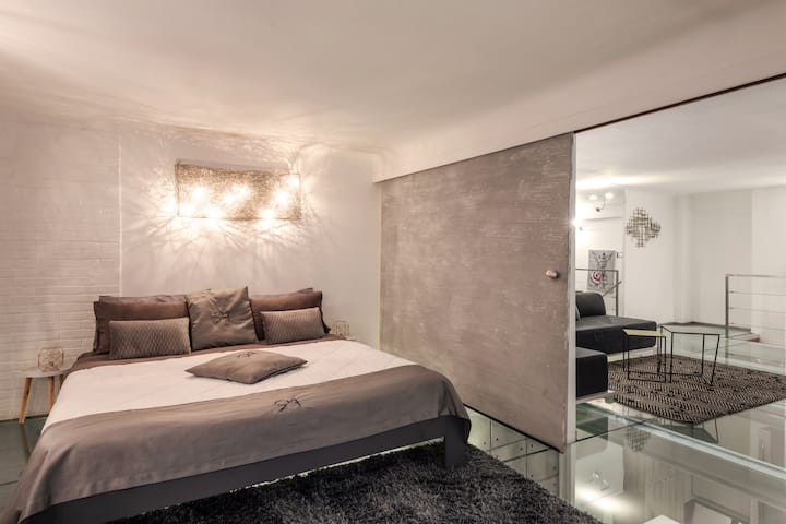 Double bed upstairs on glass floor