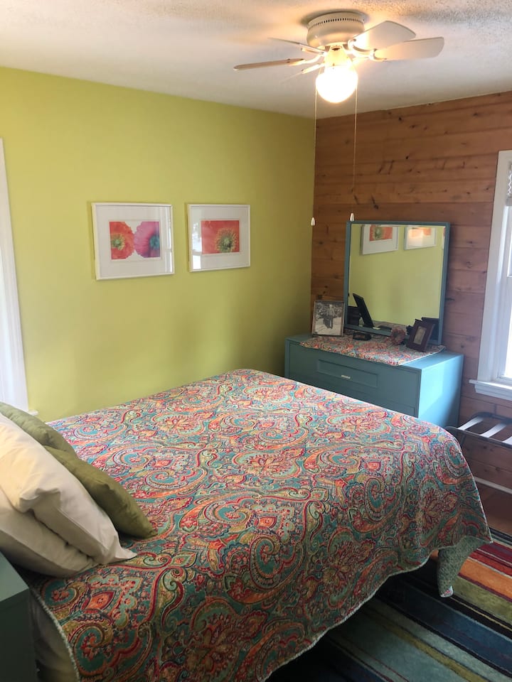 Guest bedroom with queen bed on main floor.