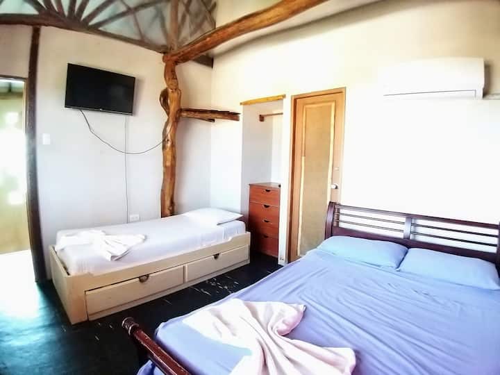 Room with 2-seater bed and two 1-plazed beds.

Shared bathroom, upstairs room, no air conditioner 